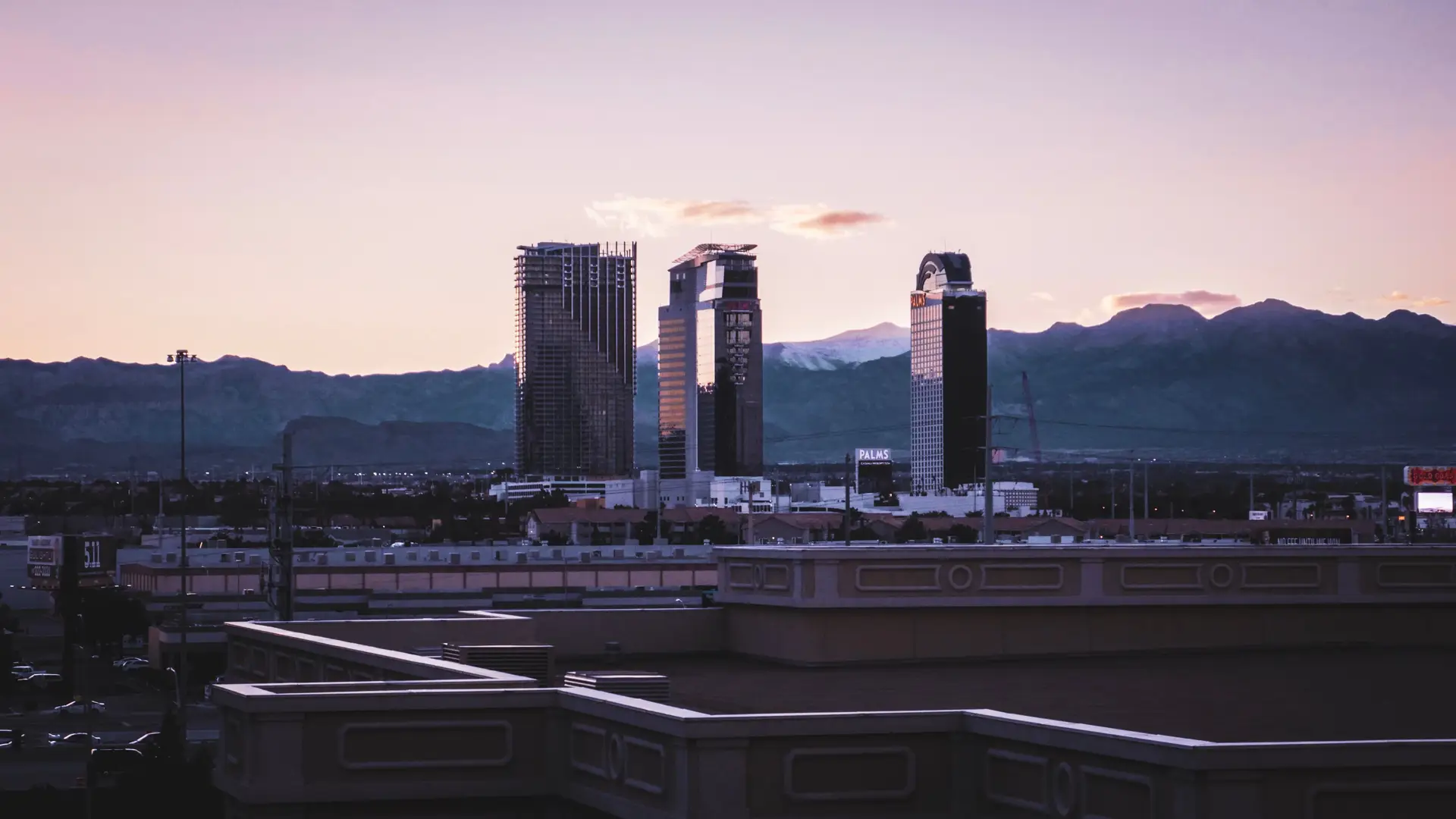 Twilight view of the resort skyline against a deep navy mountain silhouette