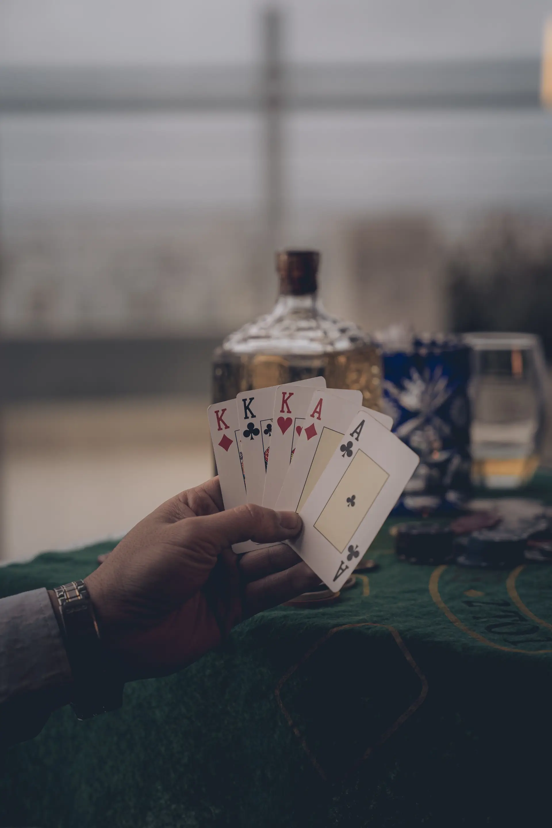 Person holding a poker hand of four kings