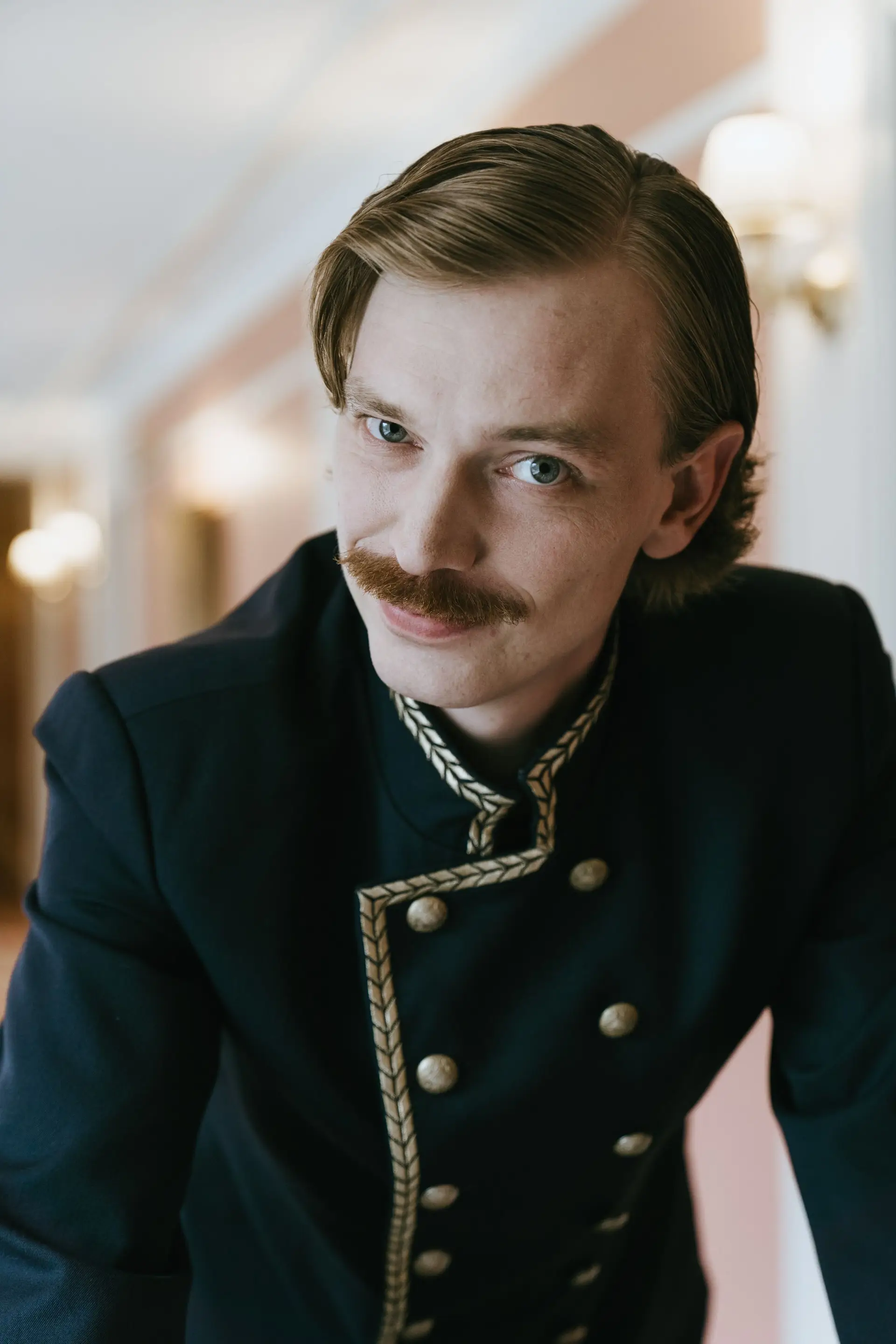 Charming hospitality staff member in uniform smiling
