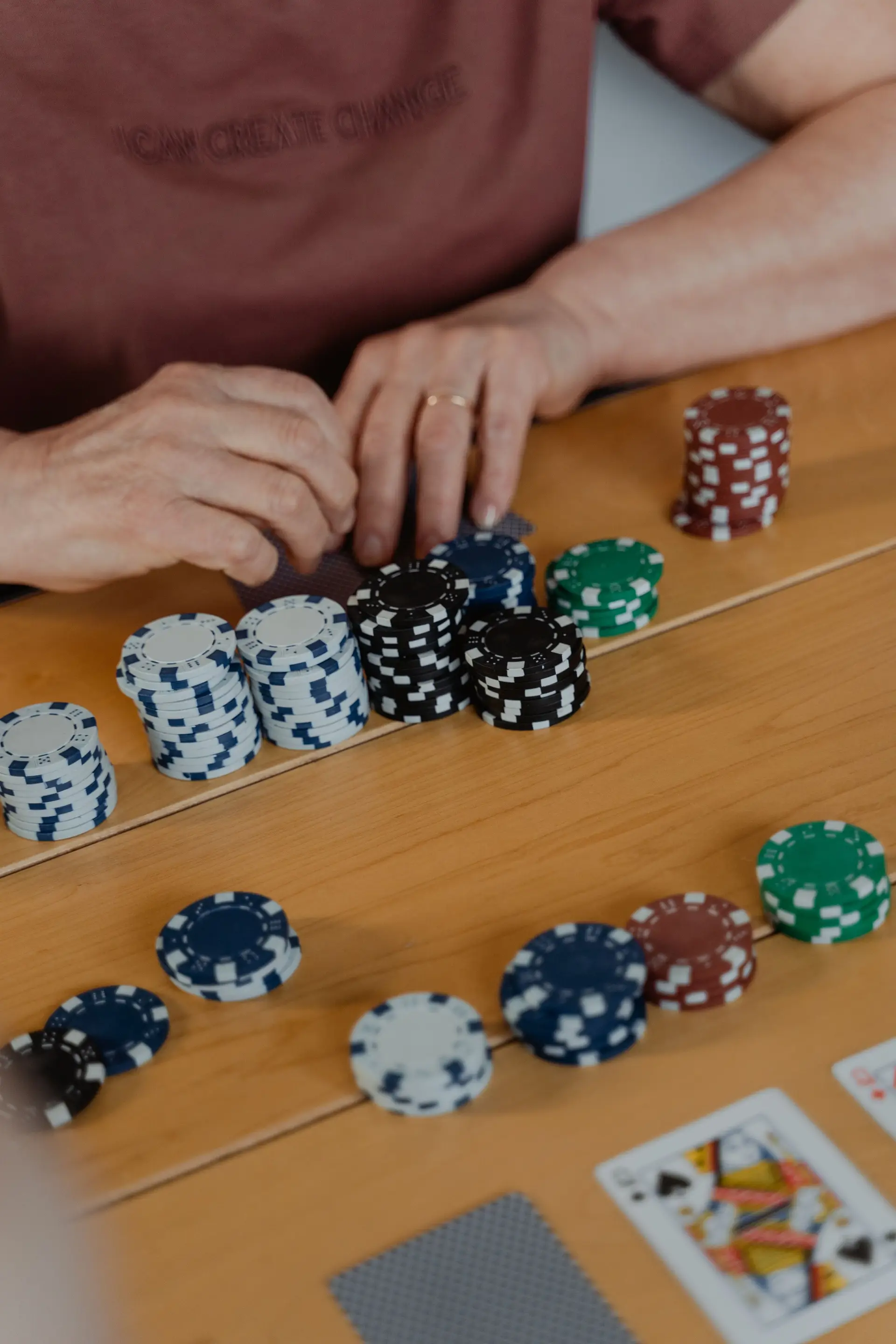 Poker chips and player hands during game