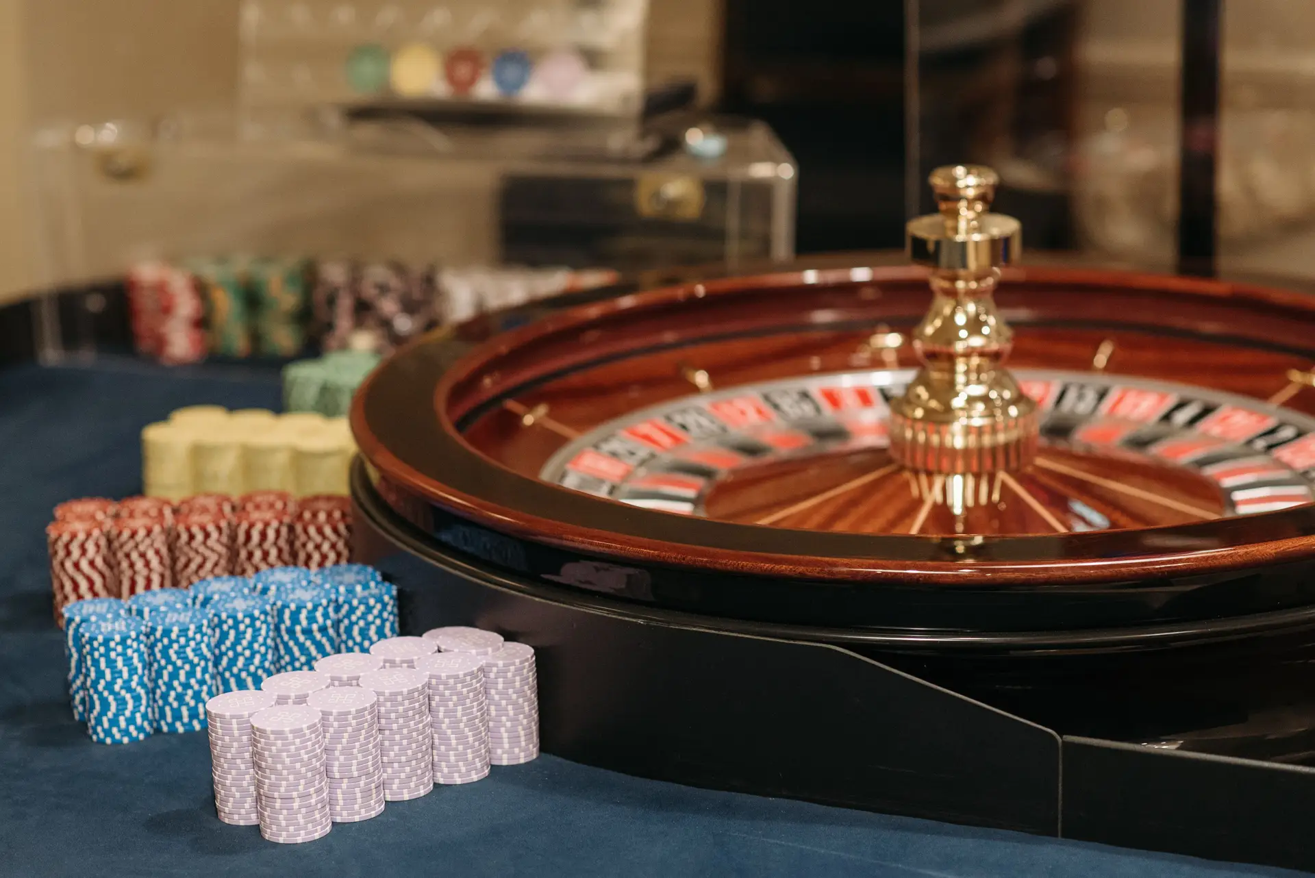 Close-up of a roulette wheel and stacked poker chips in a luxury setting